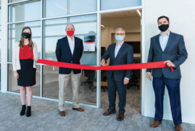 Digital team cutting the ribbon in front of the new Customer Experience Center