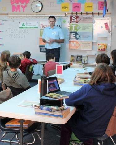 simmons associate teaching financial literacy in elementary classroom