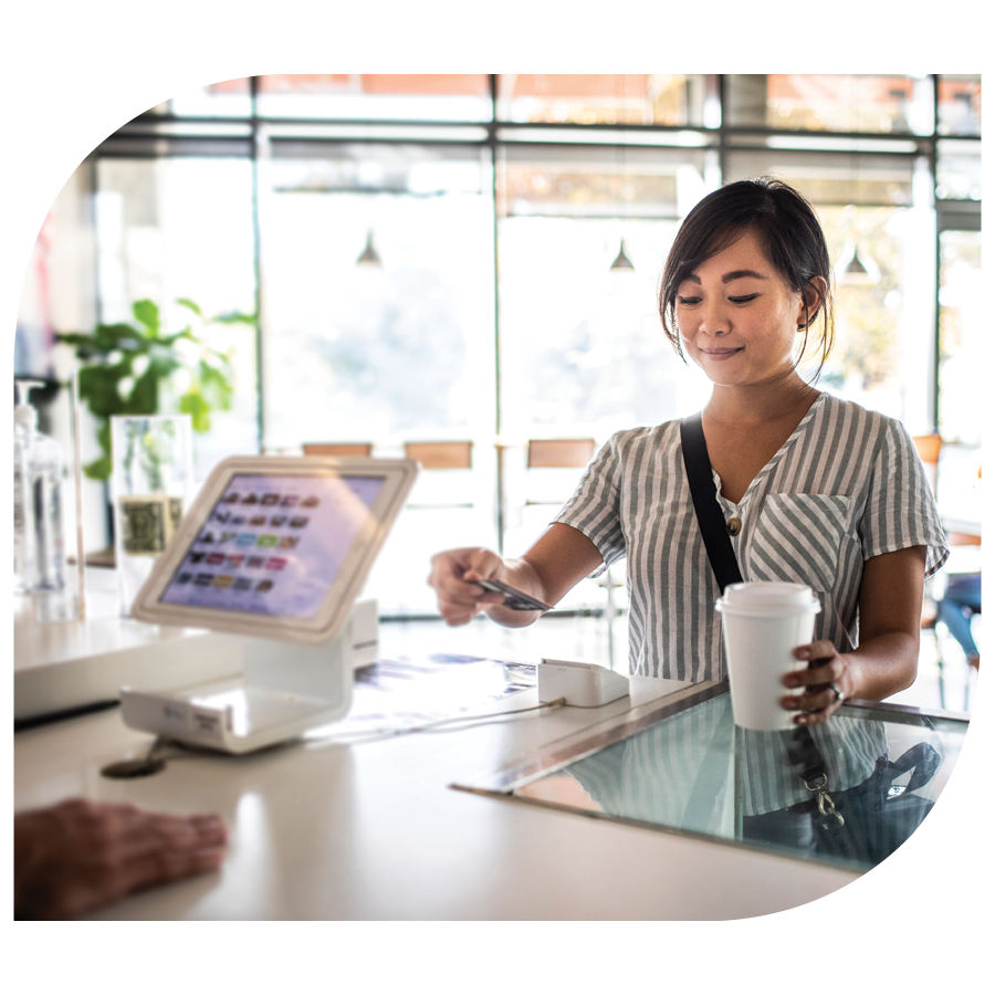 woman paying for coffe with debit card