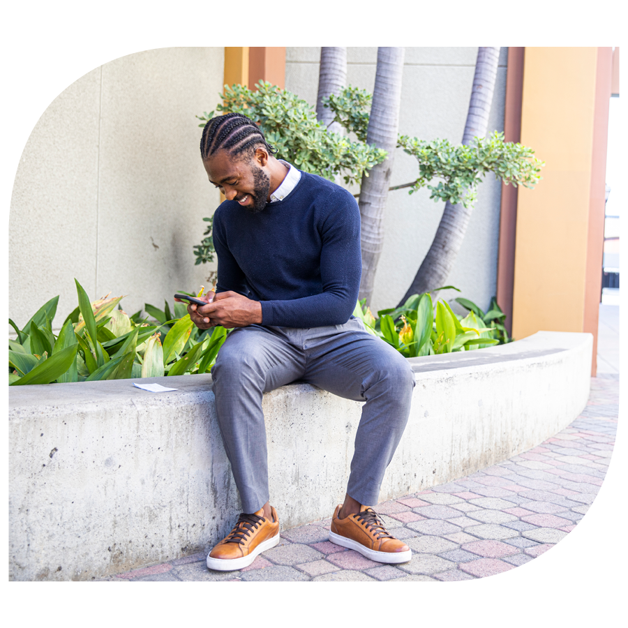 man using phone to mobile deposit a check