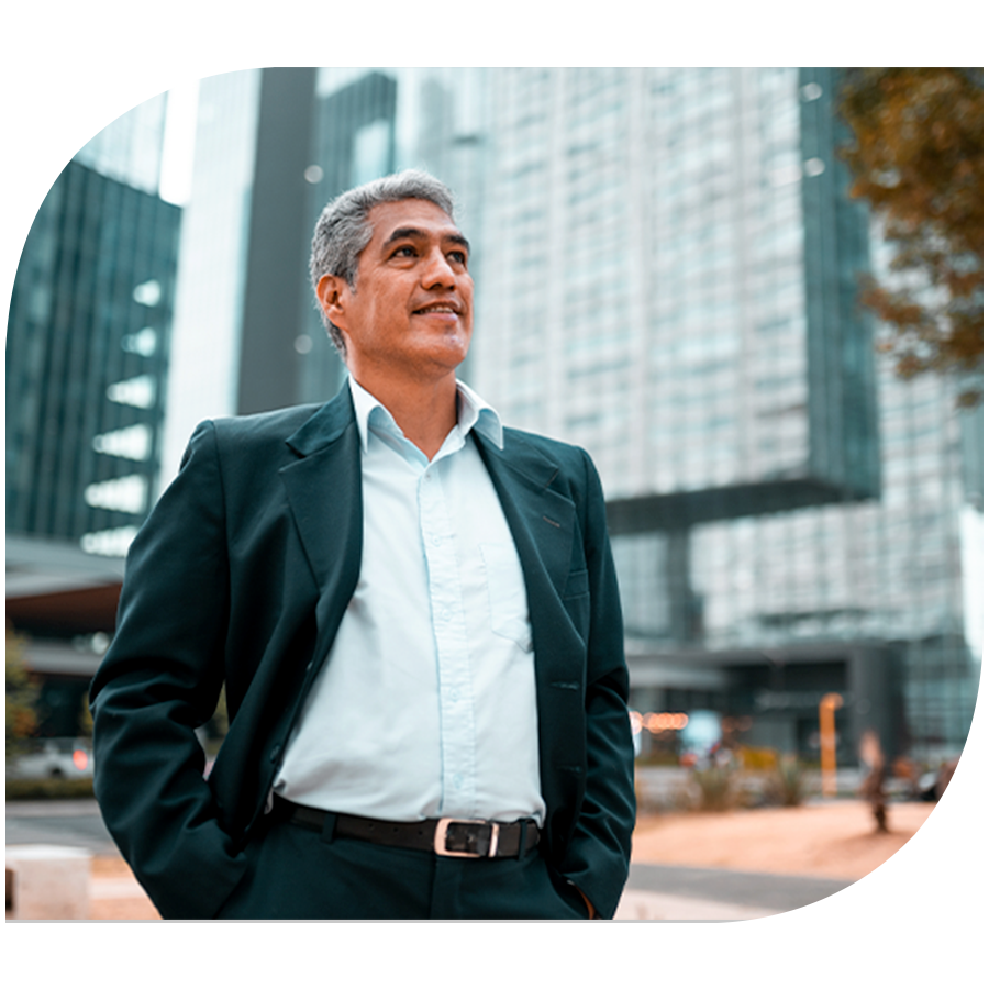 man standing in front of large downtown building