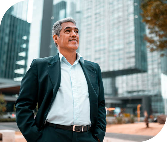 man standing in front of large downtown building