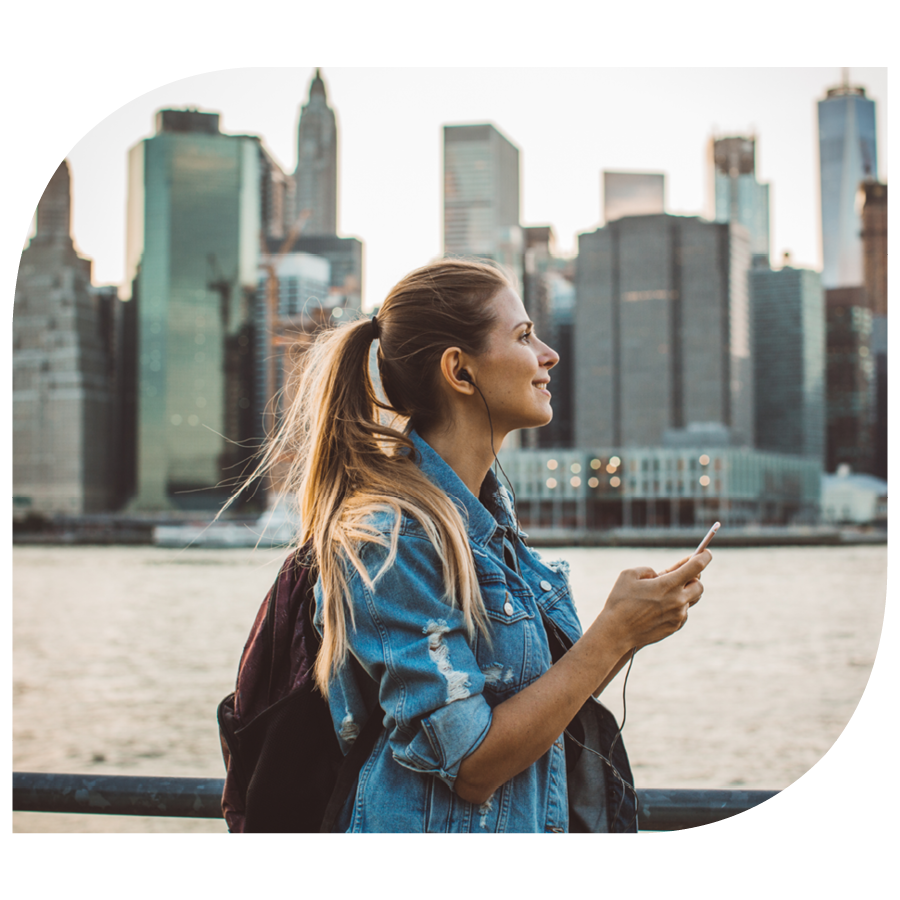 young woman exploring new york city wearing headphones