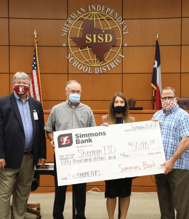 simmons bank associates donating a check to to the Sherman Independent School District