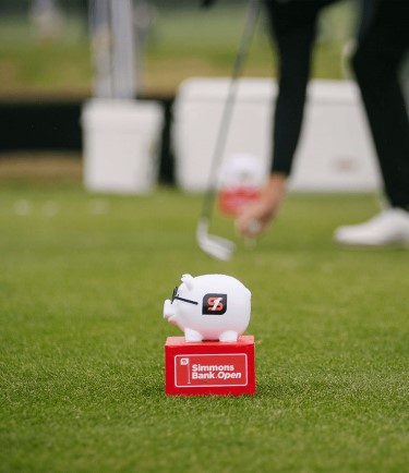 Simmons Bank Open piggy bank on a golf field
