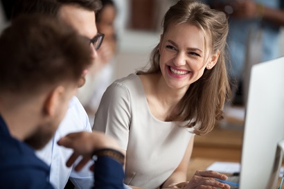 Seated person smiling at coworkers