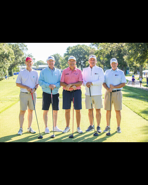Five men at the golf course holding clubs