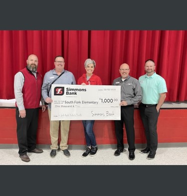 simmons associates posing for photo with donation check for south fork elementary